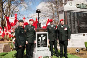 Soldiers stand next to the newly unveiled Afghanistan War Memorial in Woodstock, April 11, 2015. Bev Todd pays respect to her son Pte. Tyler Todd at the Afghanistan War Memorial, April, 11, 2015. Photo Courtesy of: Kevin Vyse Photography