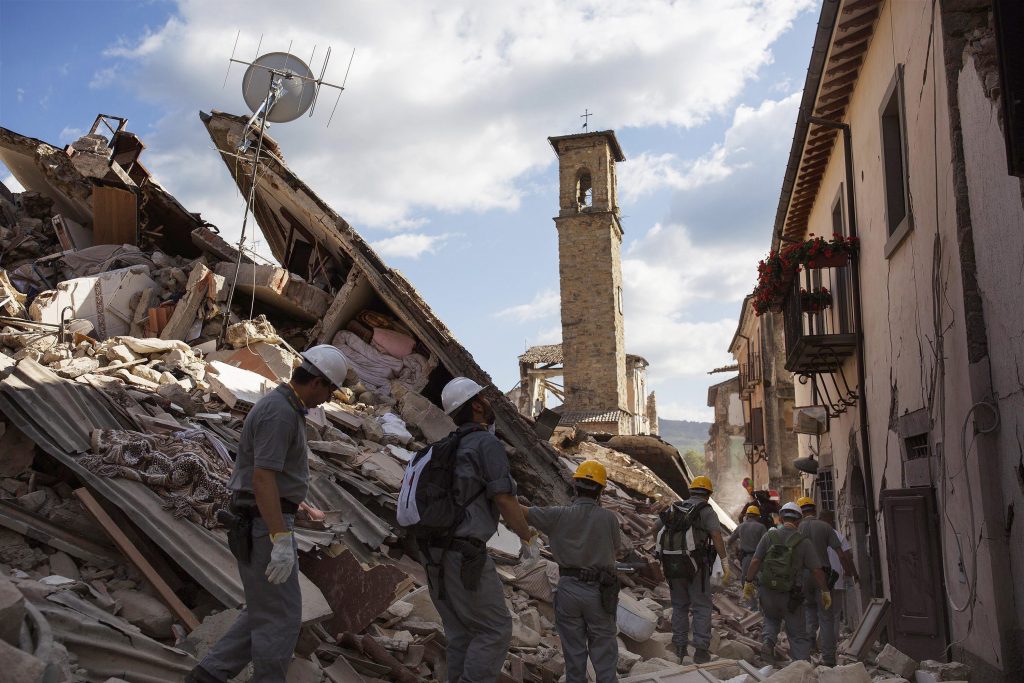 Rescuers make their way through rubble in Accumoli, central Italy, Friday, Aug. 26, 2016, two days after an earthquake. Strong aftershocks rattled residents and rescue crews alike Friday as hopes began to dim that rescuers would find any more survivors from Italy's earthquake.. (Roberto Salomone/ANSA via AP)