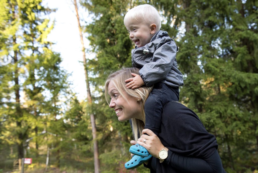 In this photo taken Tuesday, Sept. 20, 2016, Emelie Eriksson carries her son Albin outside her home in Bergshamra, Sweden. Eriksson was the first woman to have a baby after receiving a womb transplant from her mother, a revolutionary operation that links three generations of their family. (AP Photo/ Niklas Larsson)