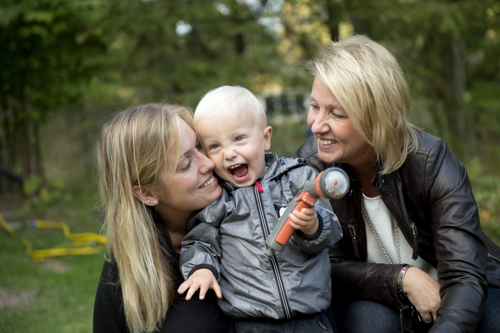 In this photo taken Tuesday, Sept. 20, 2016, Albin's mother Emelie Eriksson, left, poses for a photo with her son and her mother Marie, right, outside her home in Bergshamra, Sweden. For Emelie Eriksson, the bond she shares with her son Albin is particularly unique: both Emelie and Albin were born from the same womb, after Emelie received her motherÄôs transplanted uterus in a revolutionary operation that links three generations of their family.  (AP Photo/ Niklas Larsson)