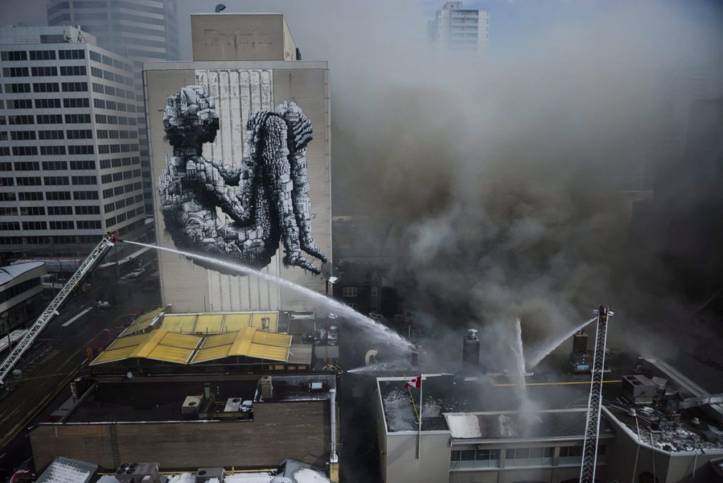 Firefighters battle a six-alarm fire on Yonge St. south of St.Clair Ave. in Toronto on Tuesday, February 14, 2017. THE CANADIAN PRESS/Christopher Katsarov