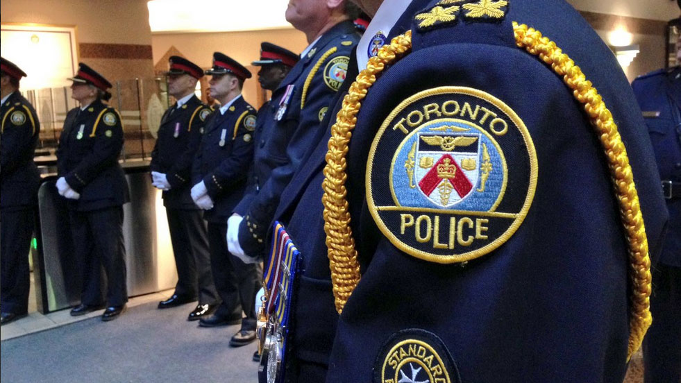 Officers stand in a line at an award ceremony at Toronto Police Service headquarters on March 29, 2017. CITYNEWS/Tony Fera