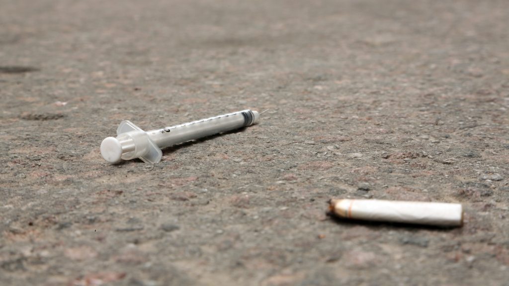 A syringe and a cigarette butt are seen on the pavement in Toronto in an undated file photo. CITYNEWS/Hugues Cormier