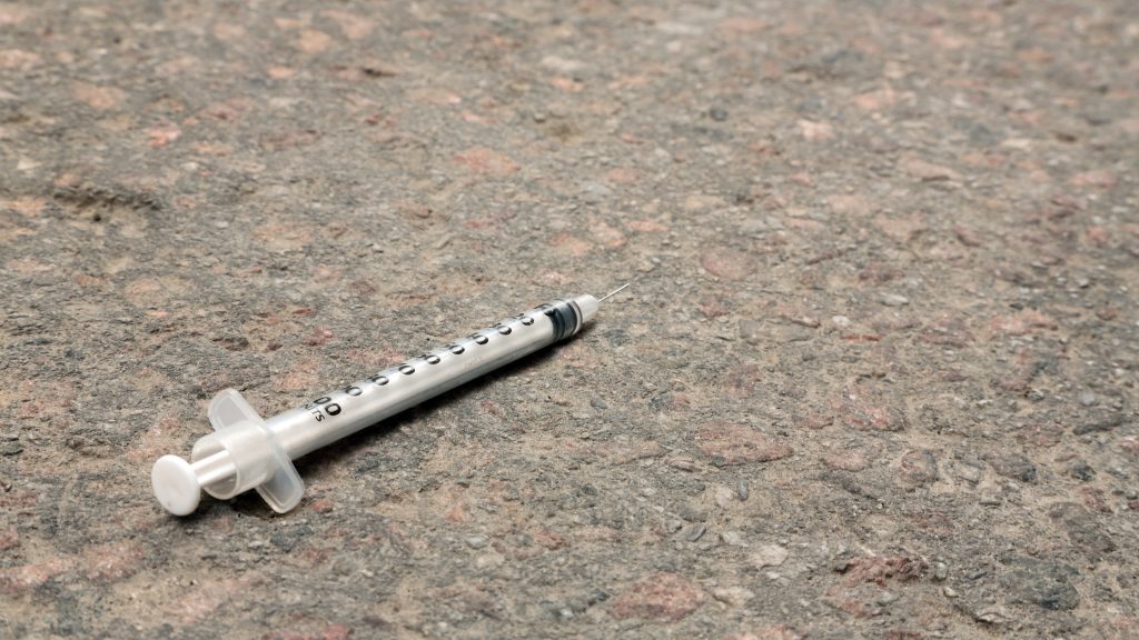 A syringe is seen on the pavement in Toronto in an undated file photo. CITYNEWS/Hugues Cormier
