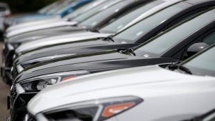 FILE - In this May 19, 2019, file photo, a line of unsold 2019 Tucson sports-utility vehicles sits at a Hyundai dealership in Littleton, Colo