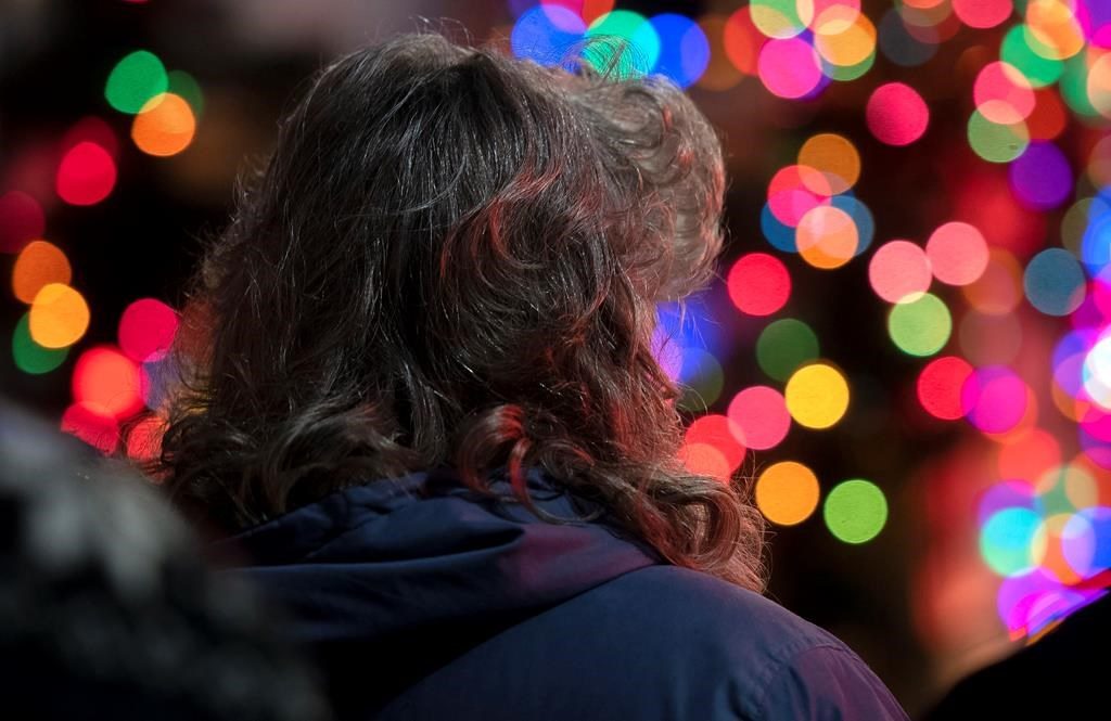 A woman looking at Christmas lights