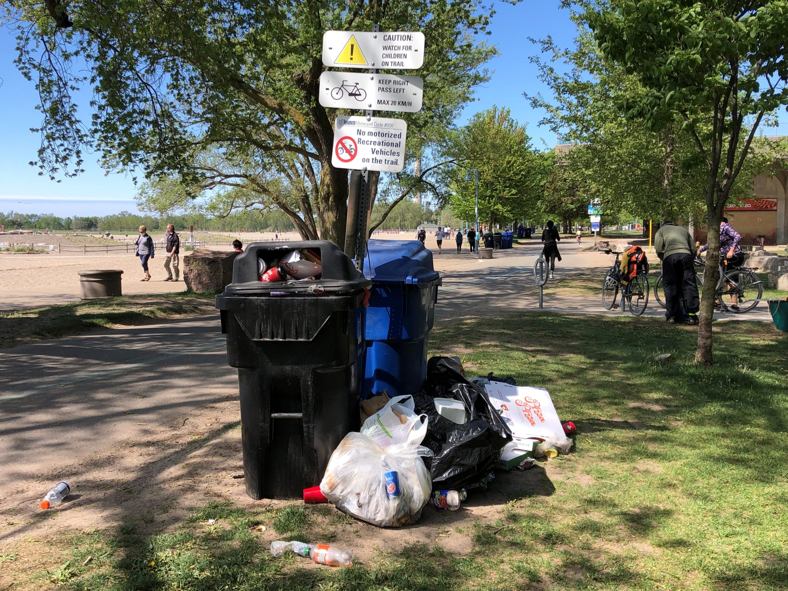 Garbage cans overflowing at Woodbine beach following a large gathering on May 23, 2021. CITYNEWS/Jerome Gange