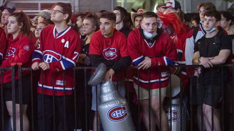 Montreal Canadiens fans look on outside the Bell Centre in Montreal, Friday, July 2, 2021, during Game 3 of the NHL Stanley Cup final against the Tampa Bay Lightning. THE CANADIAN PRESS/Graham Hughes