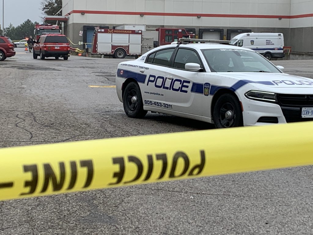 A Peel police vehicle with barrier tape outside a Brick furniture story