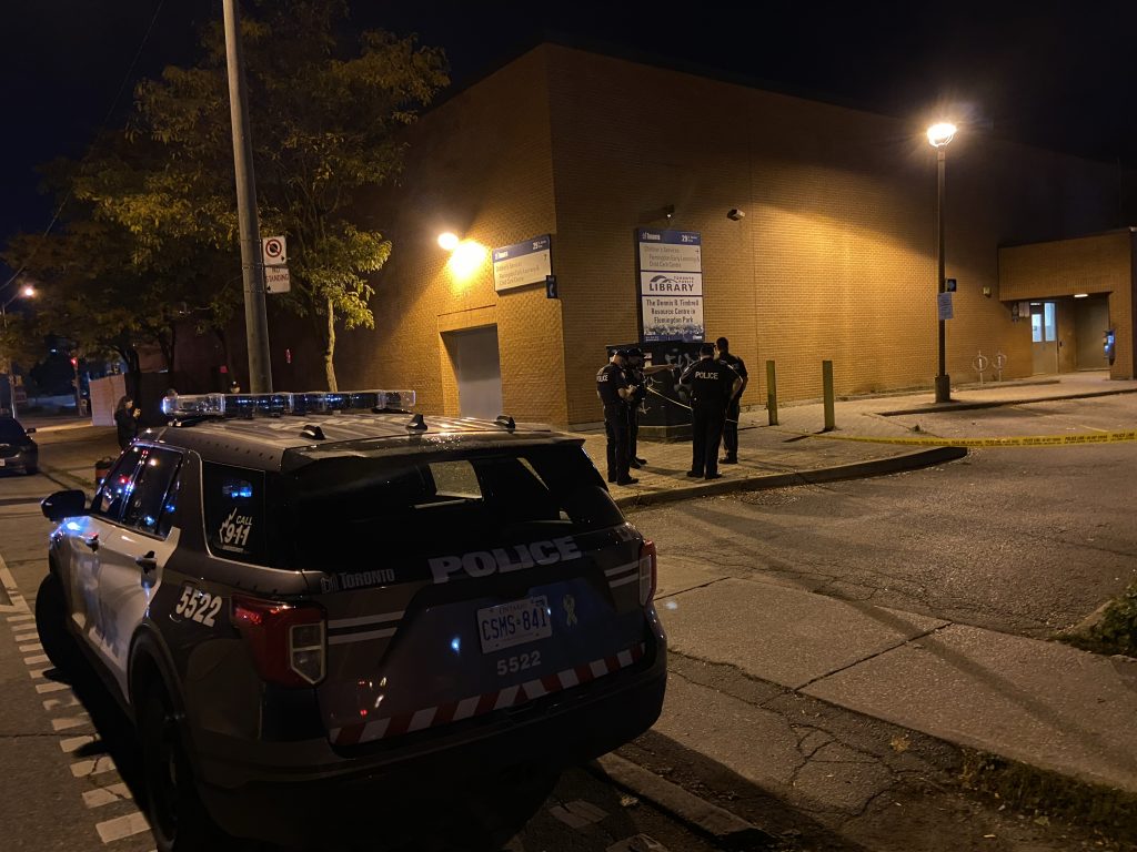 Police cruiser with police officers at a crime scene