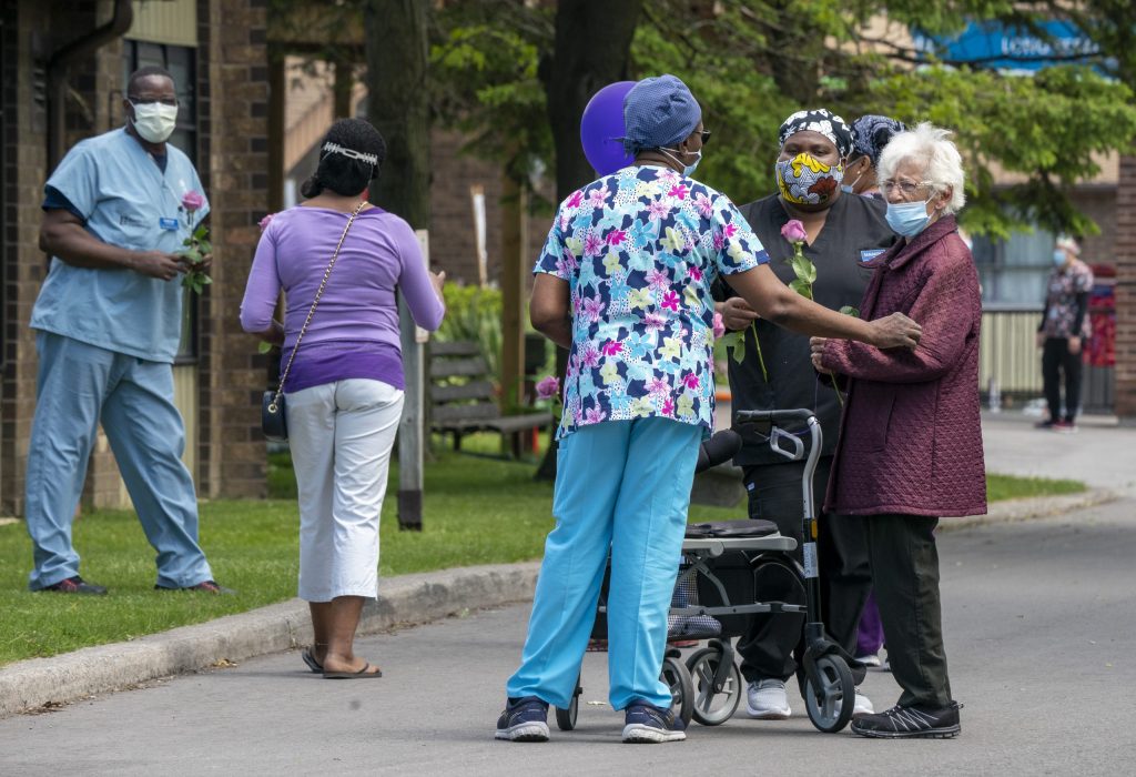 A resident chats with workers at Orchard Villa Long-Term Care in Pickering, Ontario on Monday June 1, 2020.