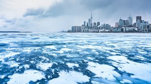 Toronto skyline seen across Lake Ontario in winter