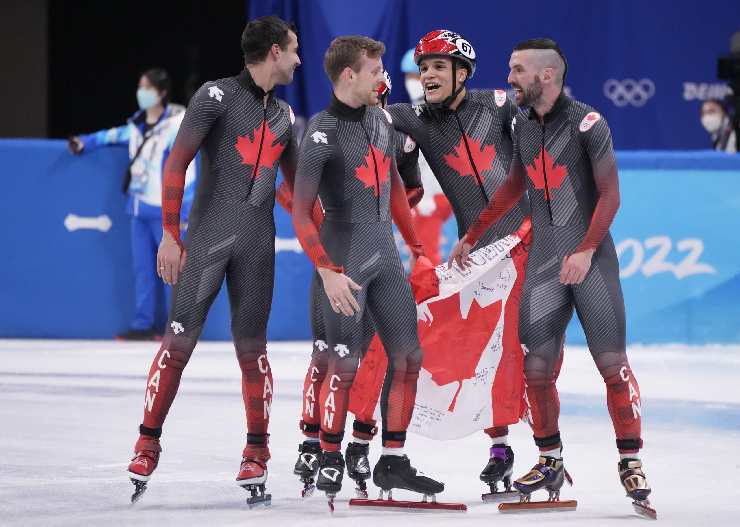 Canada’s Maxime Laoun, Pascal Dion, Jordan Pierre-Gilles and Charles Hamelin, left to right, celebrate after their gold medal win