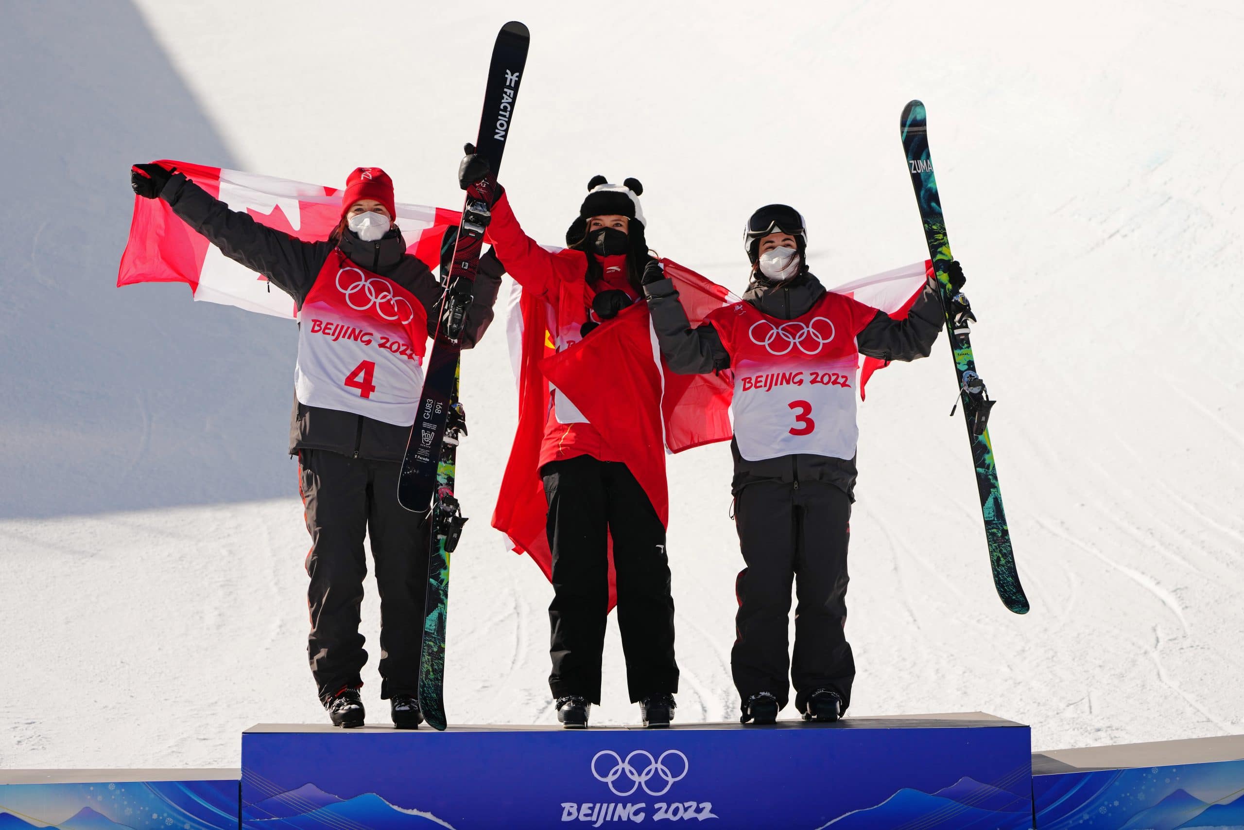 Gold medallist of China, Eileen Gu, centre,  silver medallist of Canada, Cassie Sharpe and bronze medallist of Canada, Rachael Karker celebrate following the freestyle women's ski halfpipe final