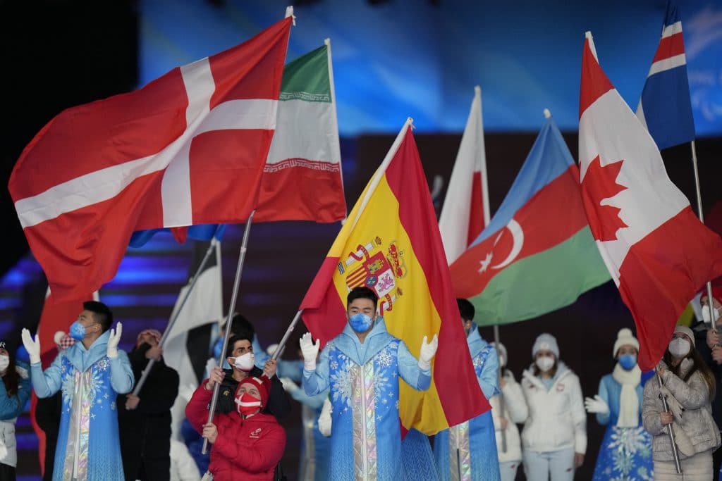 Flagbearers carry flags of participating nations during the closing ceremony