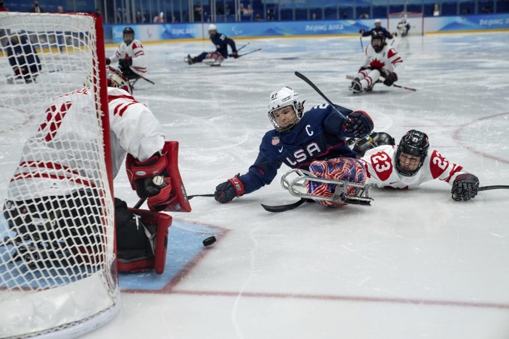 Josh Pauls of the U.S.A. and Garrett Riley of Canada collide during the Para Ice Hockey Gold Medal Game