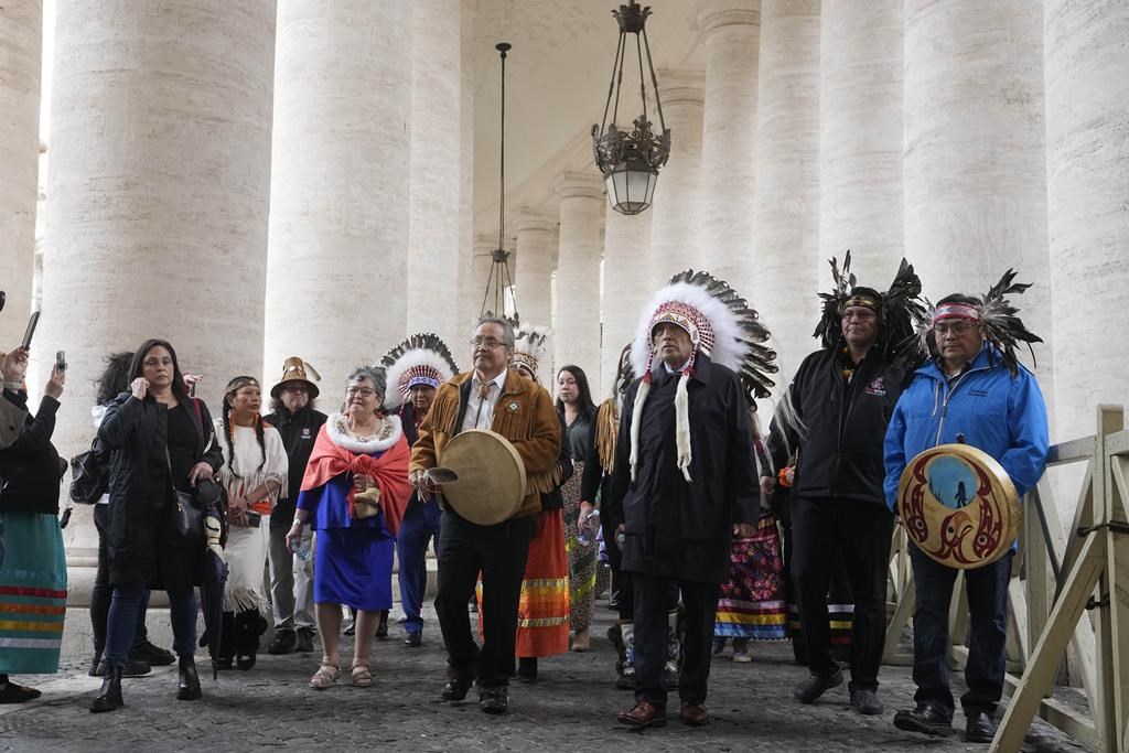 Assembly of First Nations NWT Regional Chief Gerald Antoine, center, walks with former Chief Phil Fontaine, third from right and other members of the Indigenous delegation outside St. Peter's Square at the end of a meeting with Pope Francis at the Vatican, Thursday, March 31, 2022.