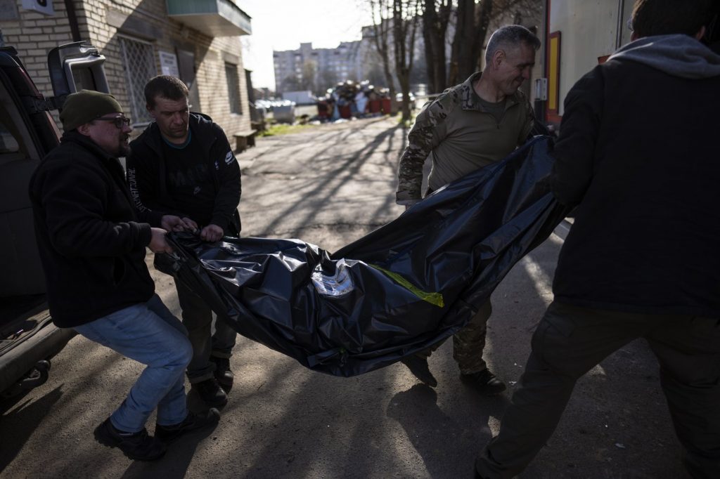 Volunteers carry the body of a man killed during the war