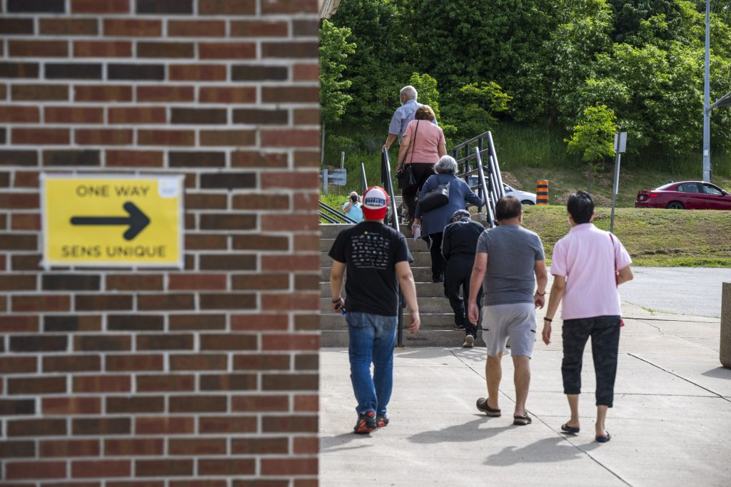 Voters walk to the cast their vote for the Ontario Provincial election at the Vaughan-Woodbridge polling station