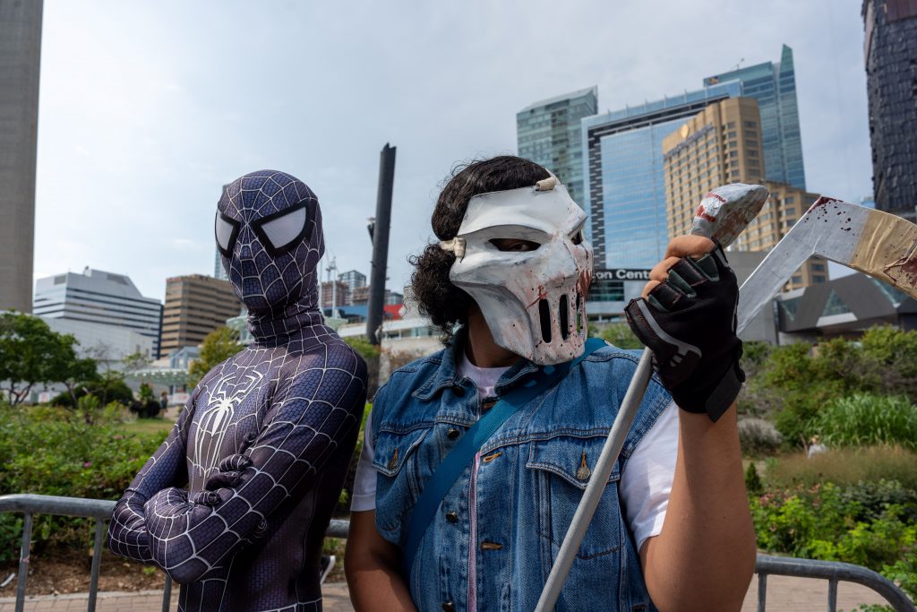 People in costumes pose outside the Metro Toronto Convention Centre ahead of the opening of Fan Expo
