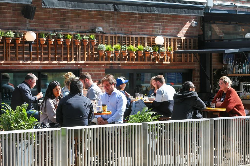 Patrons dine on a patio on King Street in Toronto