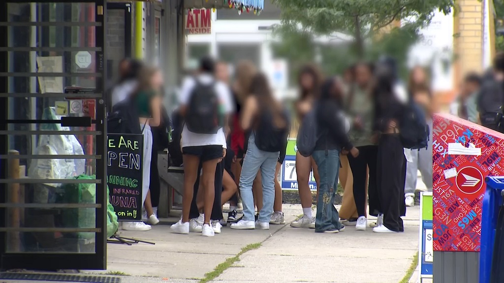 Students gather outside in an East York neighbourhood