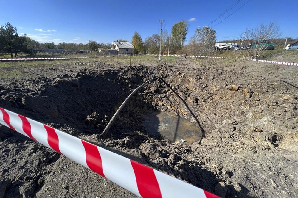 a crater created by an explosion after alleged Ukrainian military shelling