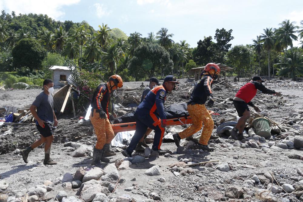 Rescuers carry a body