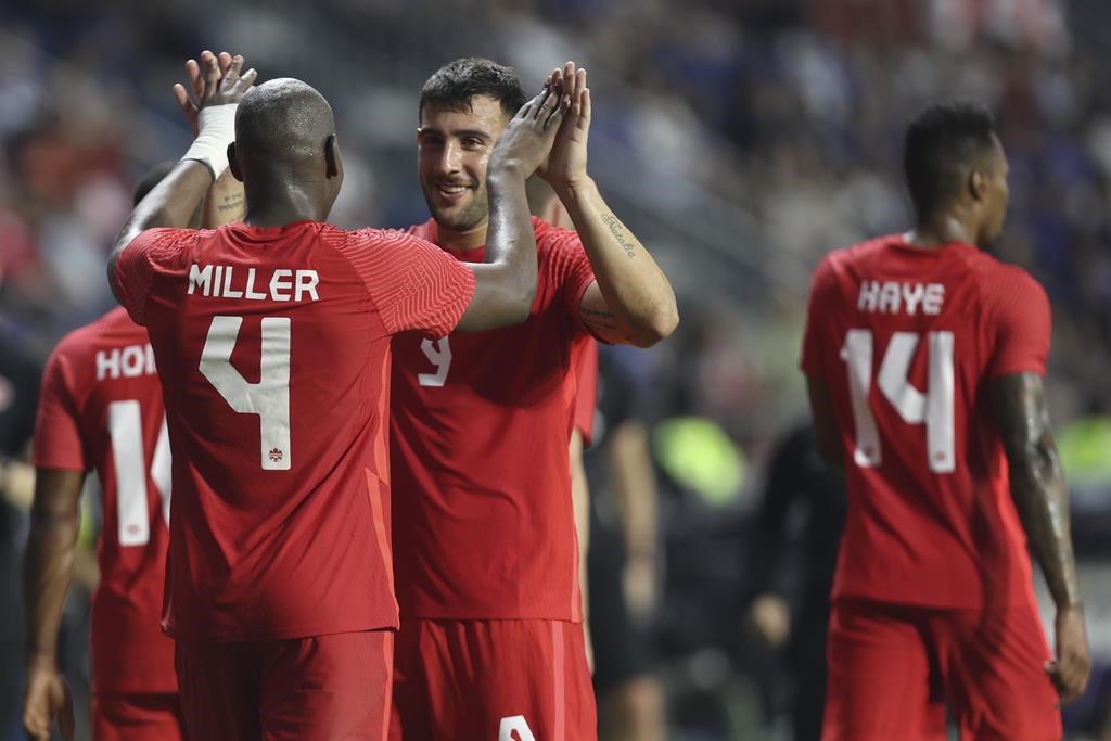Canada players celebrate after a winning goal during a friendly soccer match between Canada and Japan in Dubai on Nov. 17, 2022.