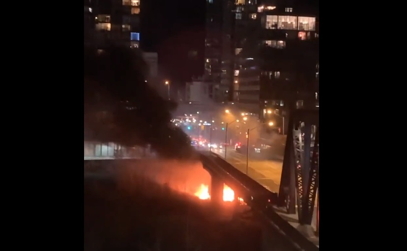 A still of a video shows a fire under the Bathurst Street bridge at Fort York Boulevard on Nov. 26, 2022.