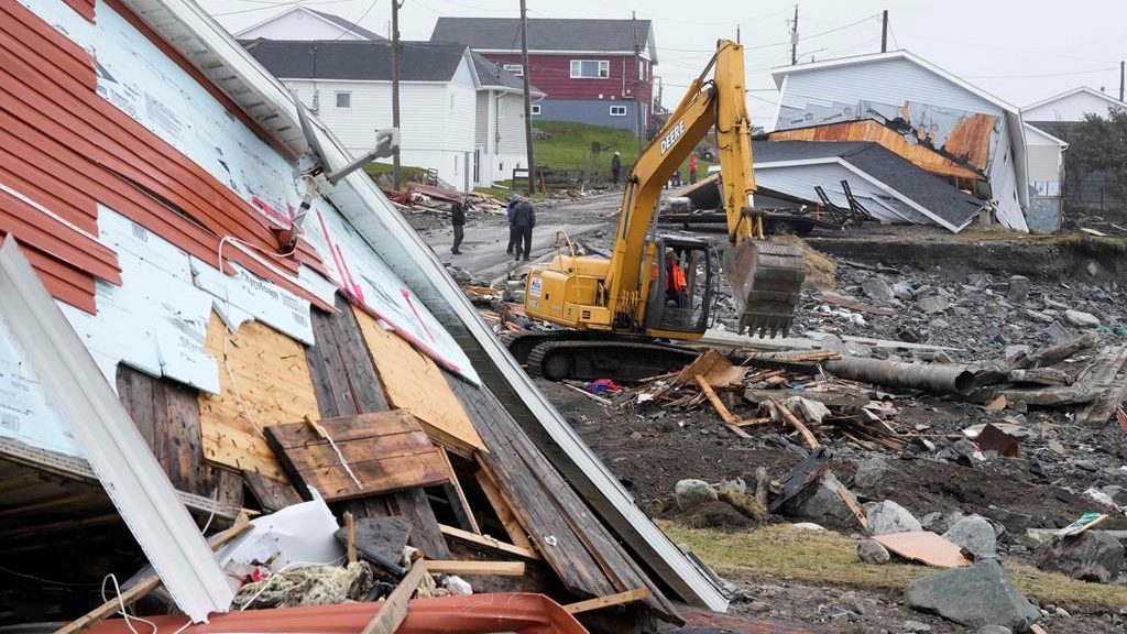 A heavy machinery operator continues the cleanup from the post-tropical storm in Port aux Basques, N.L., Sept.29, 2022