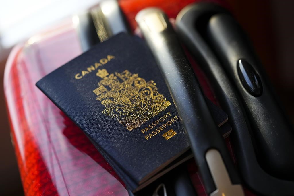 Canadian passport on a suitcase