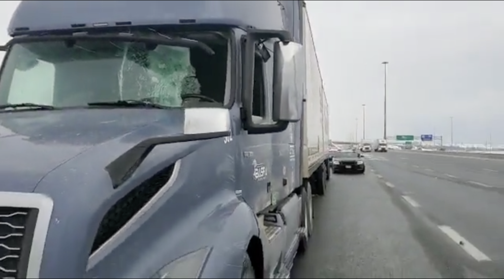 A truck's windshield is smashed on Highway 401.