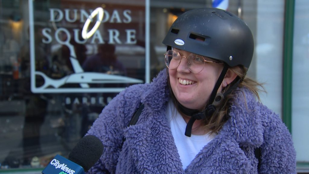 Haley Watson reacts to a video in Yonge Dundas Square