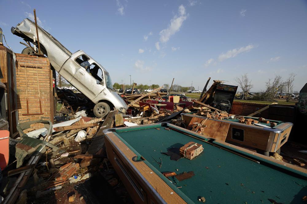 A pickup truck rests on top of a restaurant cooler