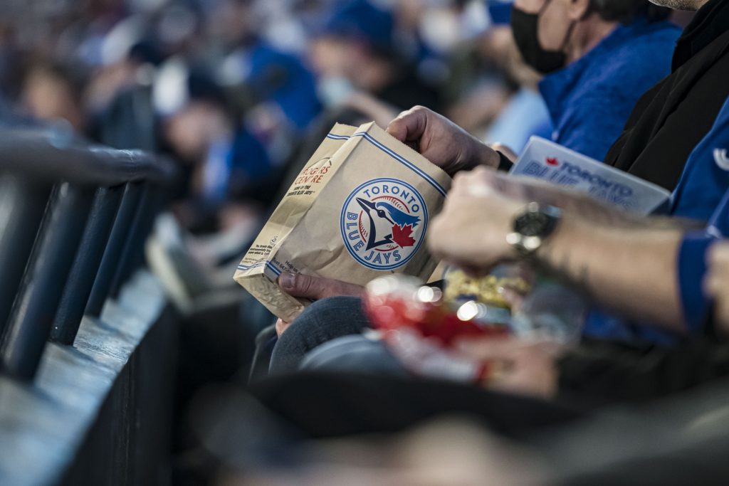 Fans hands holding food at Jays game