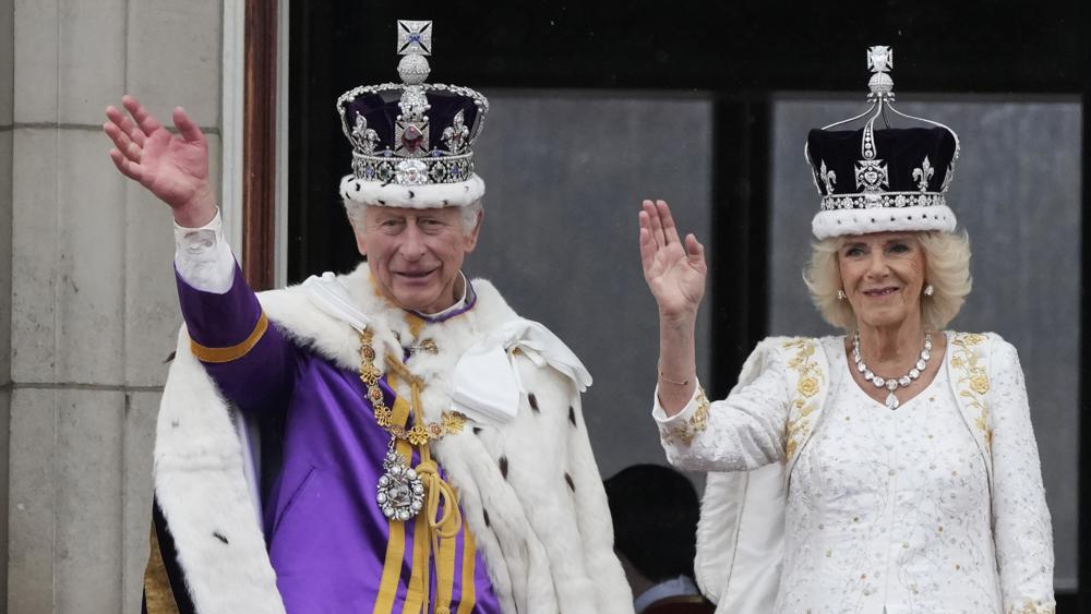 Britain's King Charles III and Queen Camilla wave to the crowds from the balcony of Buckingham Palace after the coronation ceremony in London, Saturday, May 6, 2023.