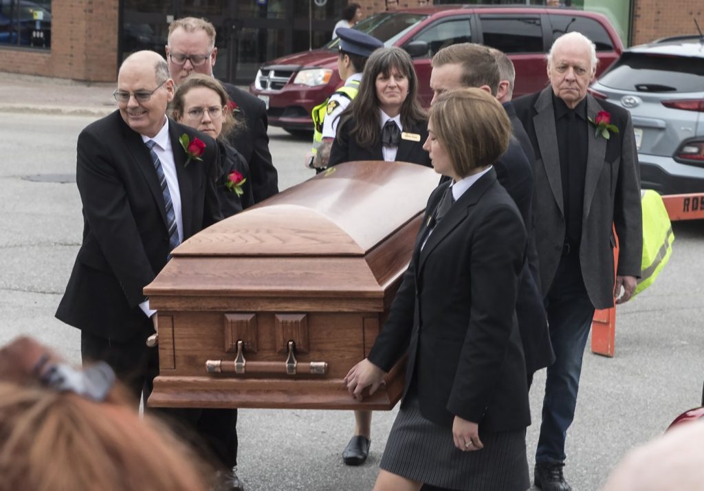 Family members carry the casket of Gordon Lightfoot into St. Paul's United Church