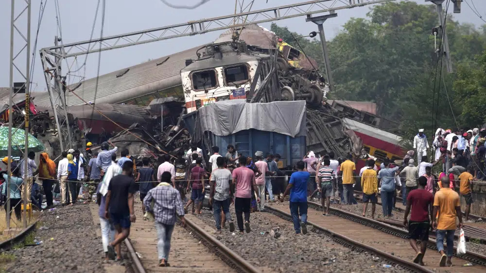 Rescuers work at the site of passenger trains that derailed