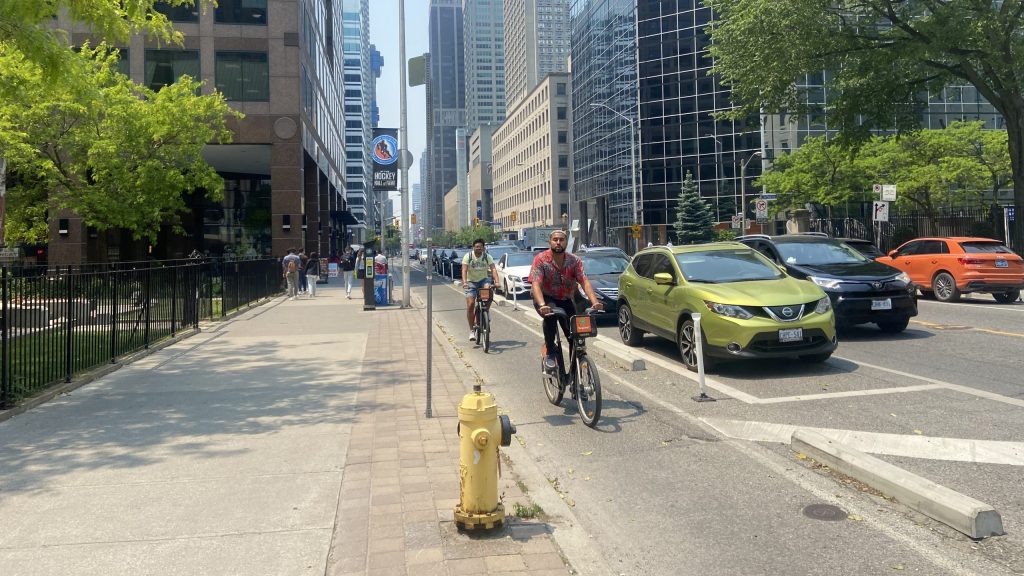 Cyclists riding in the bike lane on Bloor Street East in Toronto, Ontario on June 7, 2023.