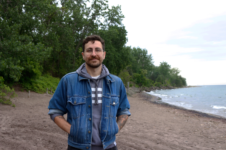 Travis Myers, co-founder, Friends of Hanlan’s stands on Hanlan’s Point Beach. 