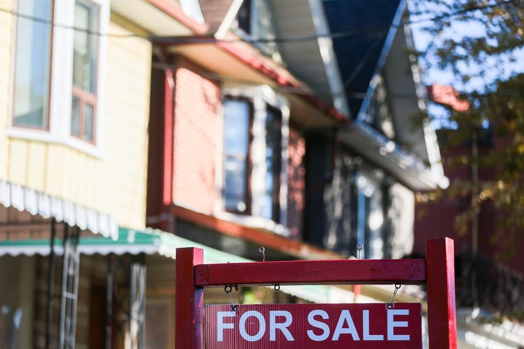 A real estate sign is displayed in front of a house in Toronto