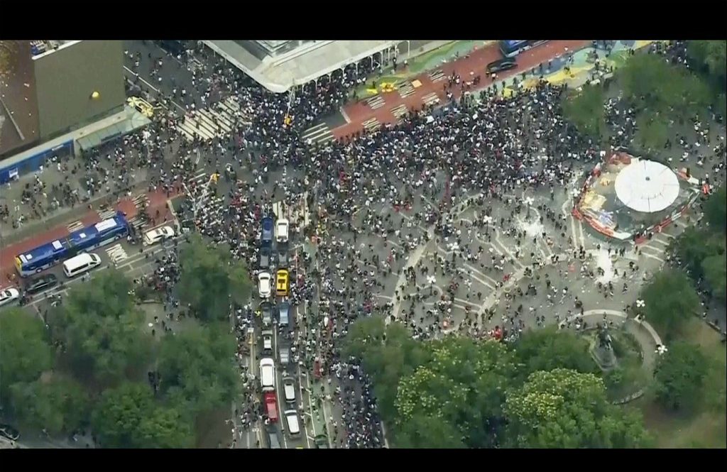 a crowd moves through Union Square