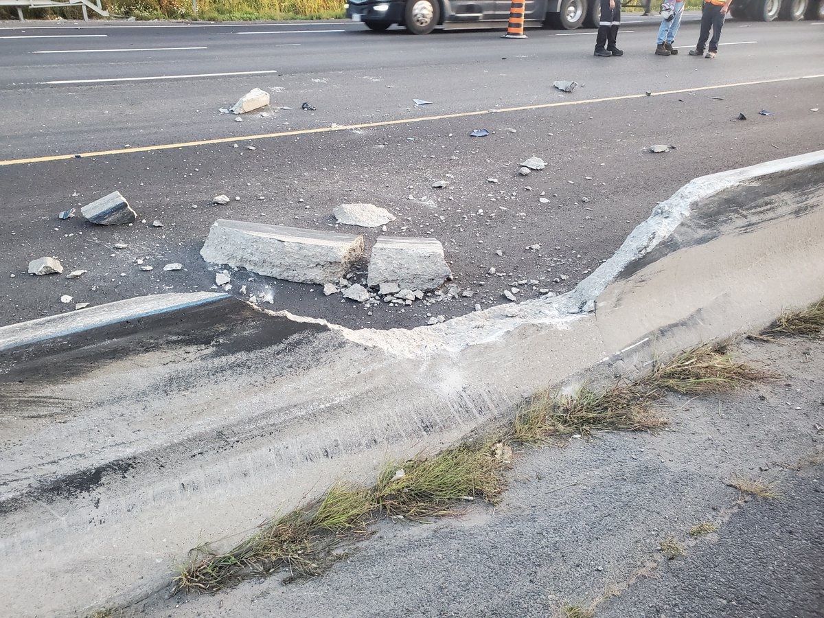 Damage to the guiderail after a tractor-trailer carrying steel and passenger vehicles crashes on Highway 401 in Bowmanville