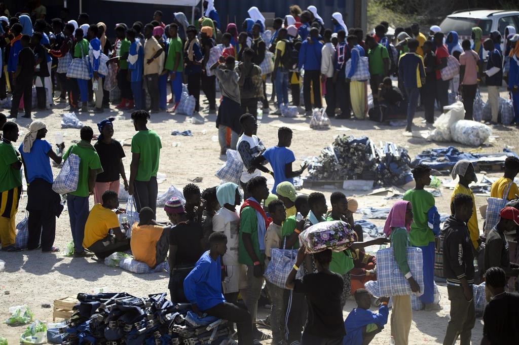 Italy works to transfer thousands of migrants who reached a tiny island in a day
