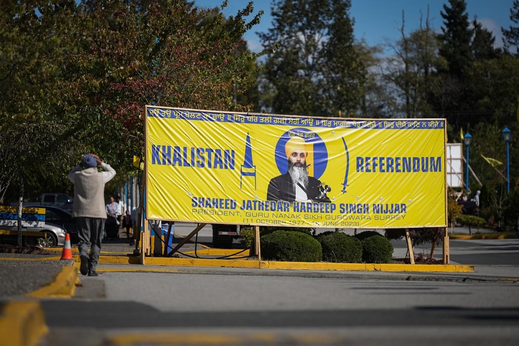 A photograph of late temple president Hardeep Singh Nijjar is seen on a banner outside the Guru Nanak Sikh Gurdwara Sahib, in Surrey, B.C.