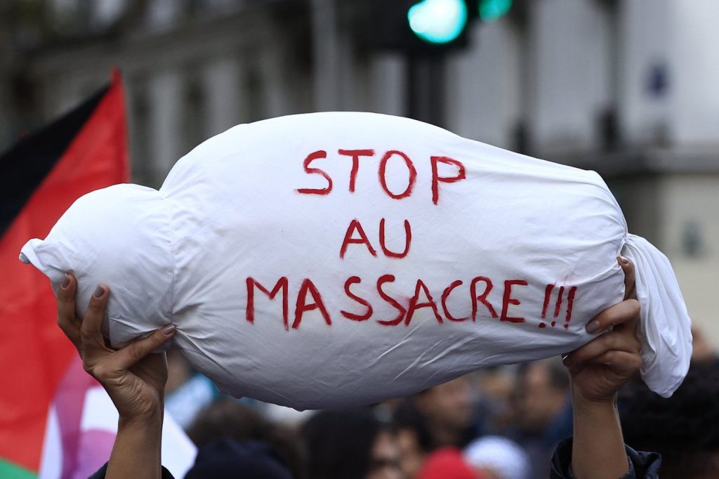 <em>A mock child's body is carried during a demonstration to support the Palestinian people in Gaza, Saturday, Nov. 4, 2023 in Paris. (AP Photo/Aurelien Morissard) </em>