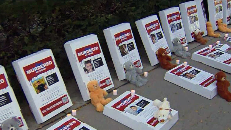 Makeshift gravestones with the names and photos of children killed in the Israel-Hamas war in Gaza are displayed outside the U.S. consulate in Toronto on Saturday, Nov. 4, 2023. CITYNEWS