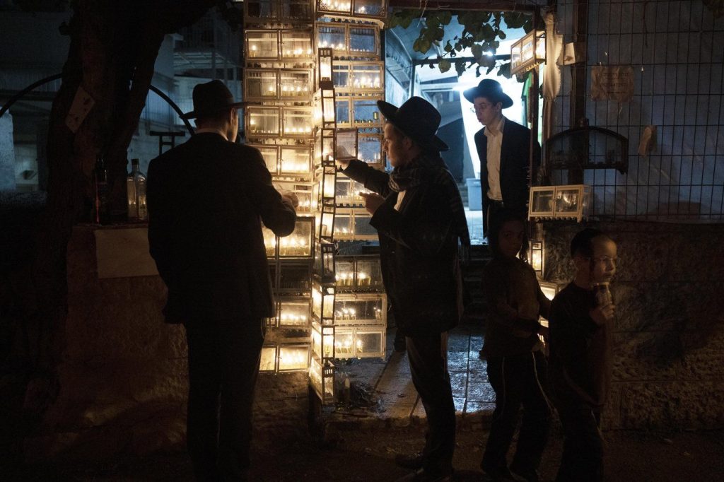 Ultra-Orthodox Jewish seminary students light candles on the fifth night of Hanukkah