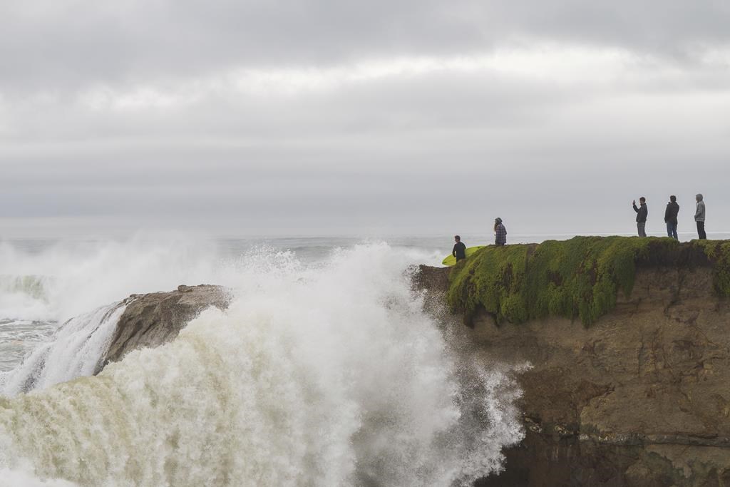 Huge surf pounds beaches on West Coast and in Hawaii with some low-lying  coastal areas flooding